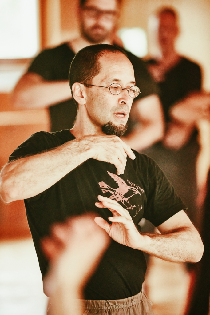 Shinichi, arms close to torso.